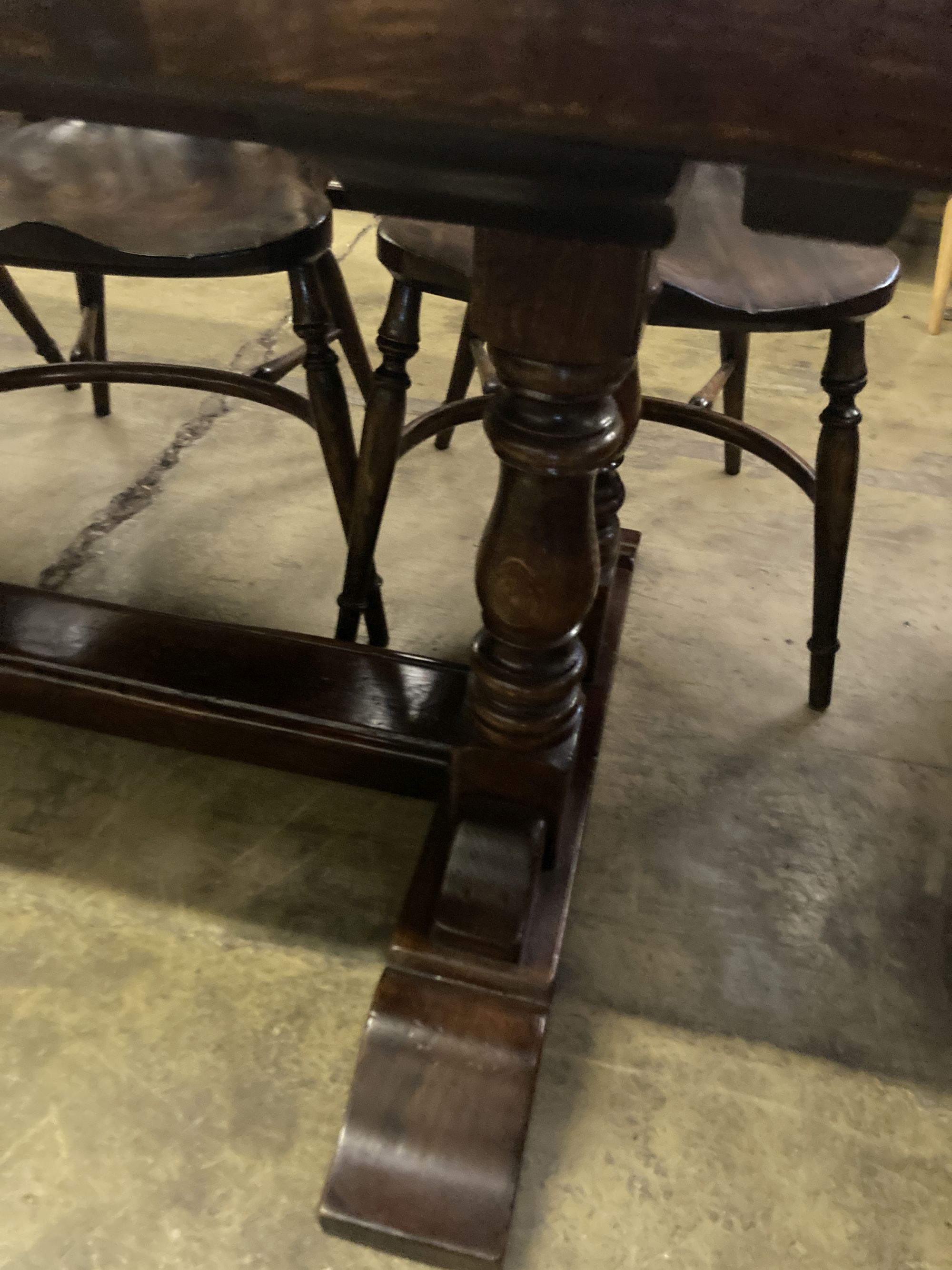 An 18th century style oak refectory table having planked top on double turned end supports, width 230cm depth 90cm height 76cm